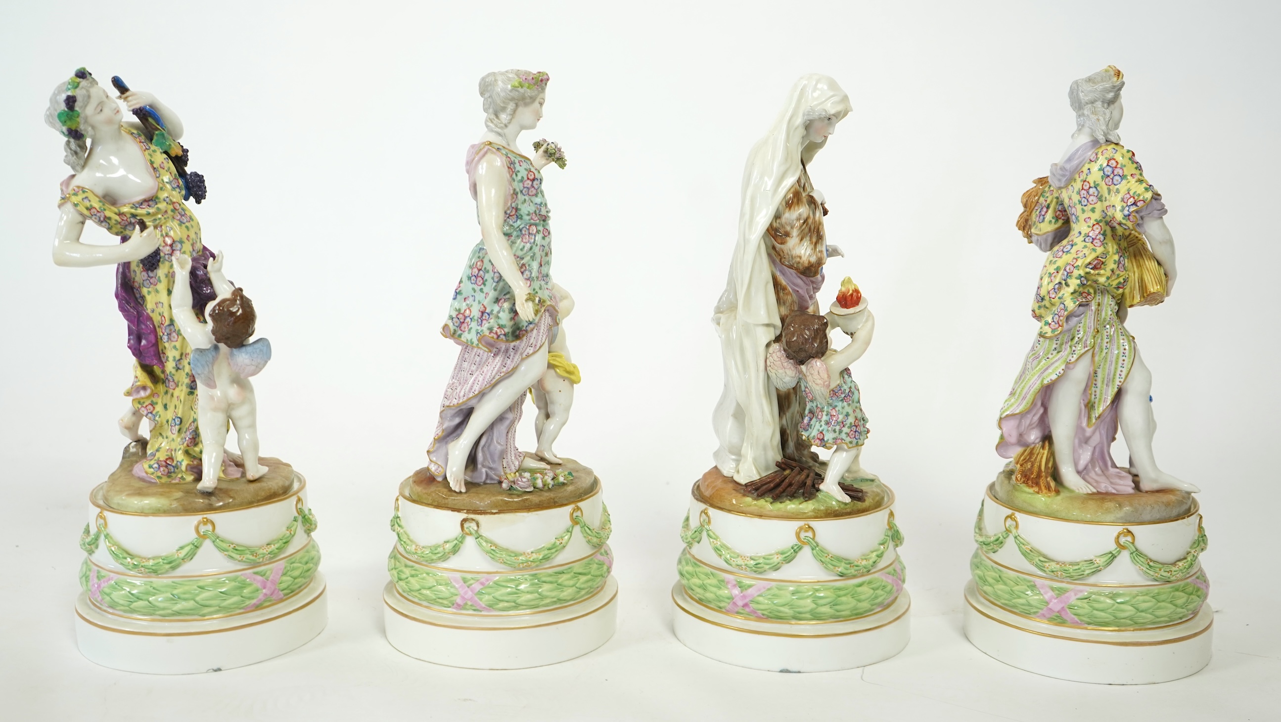 A set of four large Meissen style 'Four Seasons' groups and separate pedestals